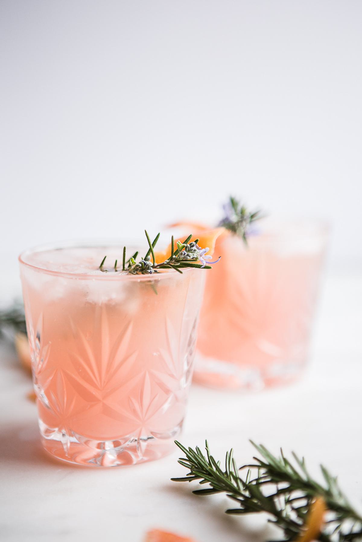 2 glasses of Grapefruit Cardamom Gin Fizz with rosemary